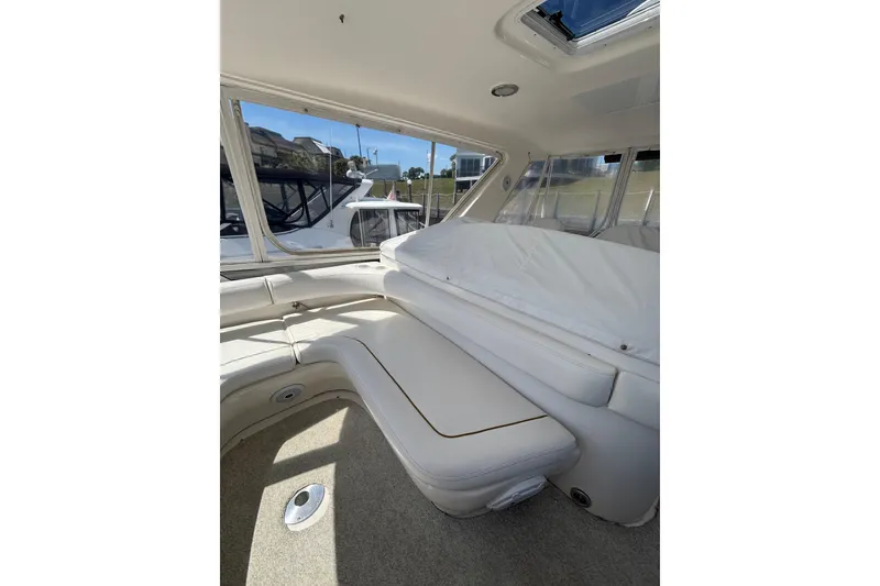 Slide: The Image of Interior view of 1999 Sea Ray 480 Sedan Bridge yacht with white seating. - 19