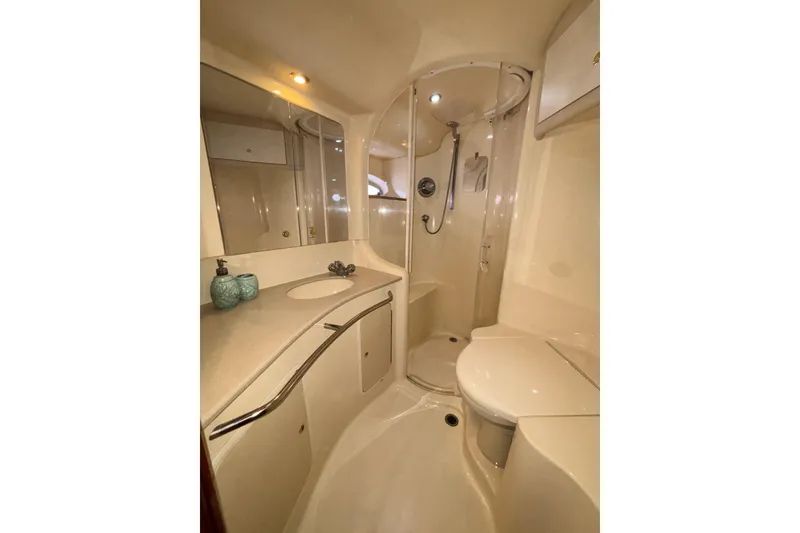 Slide: The Image of Luxurious bathroom in 1999 Sea Ray 480 Sedan Bridge yacht, featuring shower and vanity. - 75