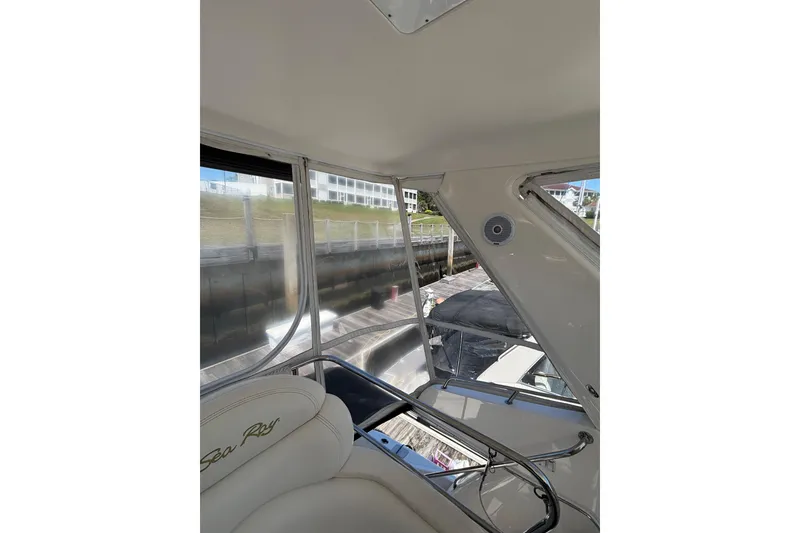 Slide: The Image of Interior view of 1999 Sea Ray 480 Sedan Bridge yacht, featuring seating and windows. - 33