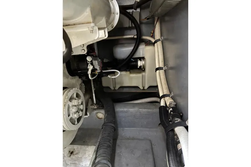 Slide: The Image of Engine compartment of a 1999 Sea Ray 480 Sedan Bridge, showcasing mechanical components and wiring. - 87