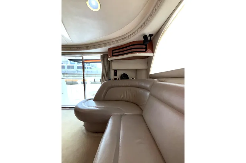 Slide: The Image of Luxurious interior of 1999 Sea Ray 480 Sedan Bridge yacht with plush seating. - 41
