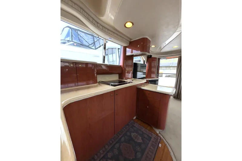 Slide: The Image of Luxurious 1999 Sea Ray 480 Sedan Bridge yacht interior with modern kitchen amenities. - 46