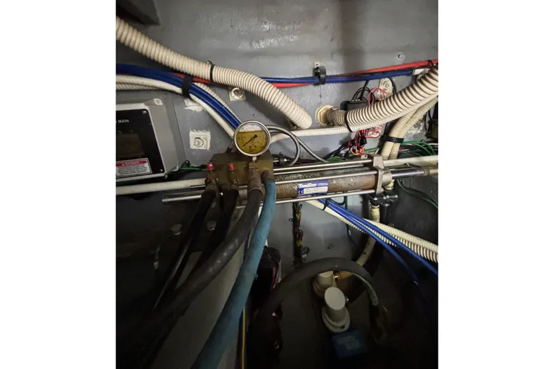 Slide: The Image of Engine room of a 1999 Sea Ray 480 Sedan Bridge with gauges and wiring. - 100