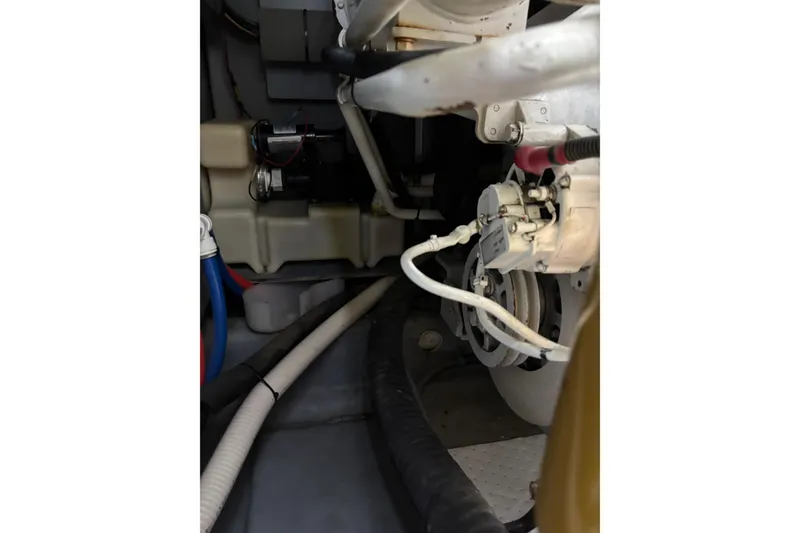 Slide: The Image of Engine room of a 1999 Sea Ray 480 Sedan Bridge, showcasing mechanical components and wiring. - 86