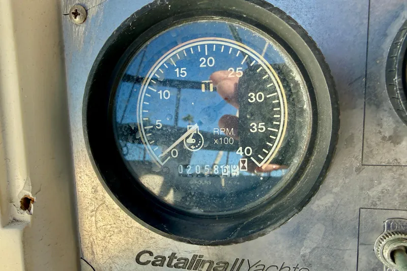 Slide: The Image of Close-up of a 1988 Catalina 34 yacht tachometer showing RPM and engine hours. - 12