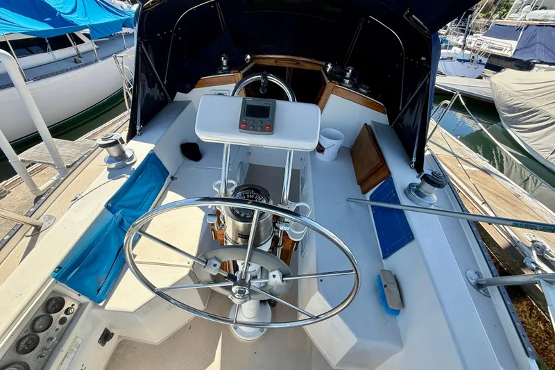 Slide: The Image of Cockpit of a 1988 Catalina 34 sailboat with steering wheel and navigation instruments. - 14