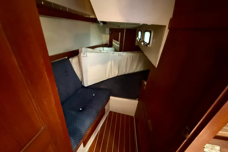 Slide: The Image of Interior cabin of a 1988 Catalina 34 sailboat with seating and windows. - 17
