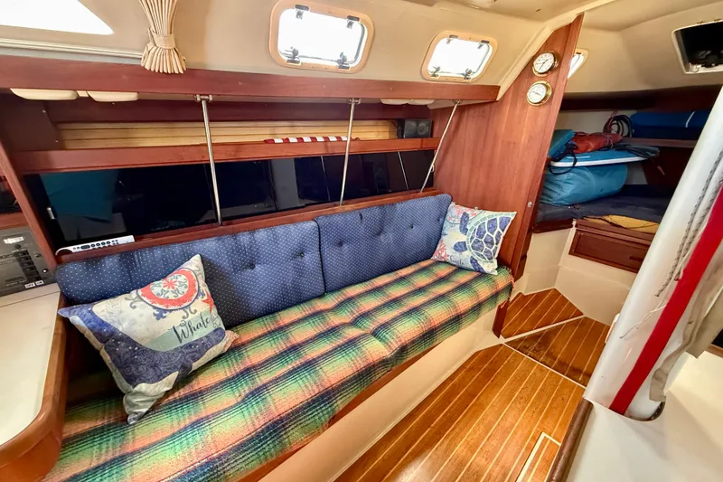 Slide: The Image of Interior of a 1988 Catalina 34 sailboat with cozy seating and nautical decor. - 20