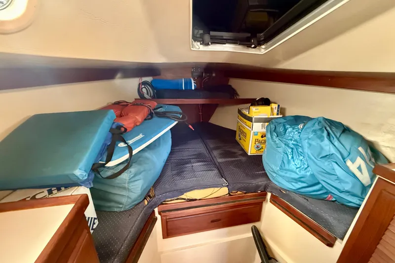 Slide: The Image of Interior cabin of a 1988 Catalina 34 sailboat with storage items. - 22