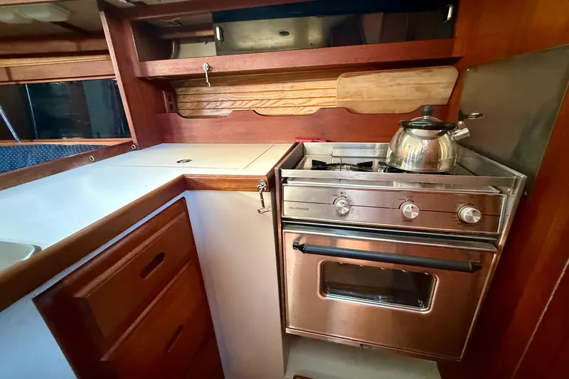 Slide: The Image of Galley kitchen in 1988 Catalina 34 sailboat with stove and kettle. - 23