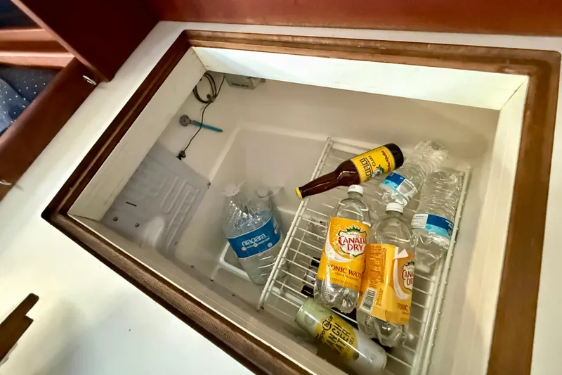 Slide: The Image of Beverages stored in a Catalina 34 sailboat's built-in cooler, including tonic water and bottled water. - 24