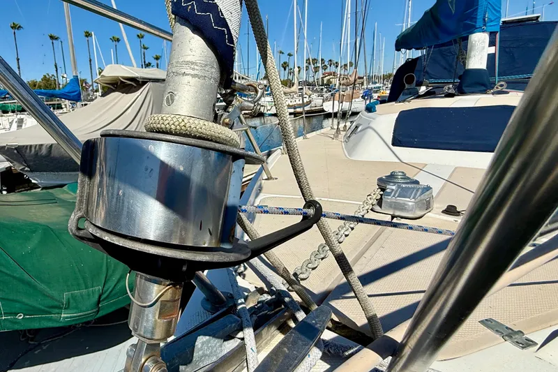 Slide: The Image of Close-up of a 1988 Catalina 34 sailboat deck with rigging and marina background. - 5