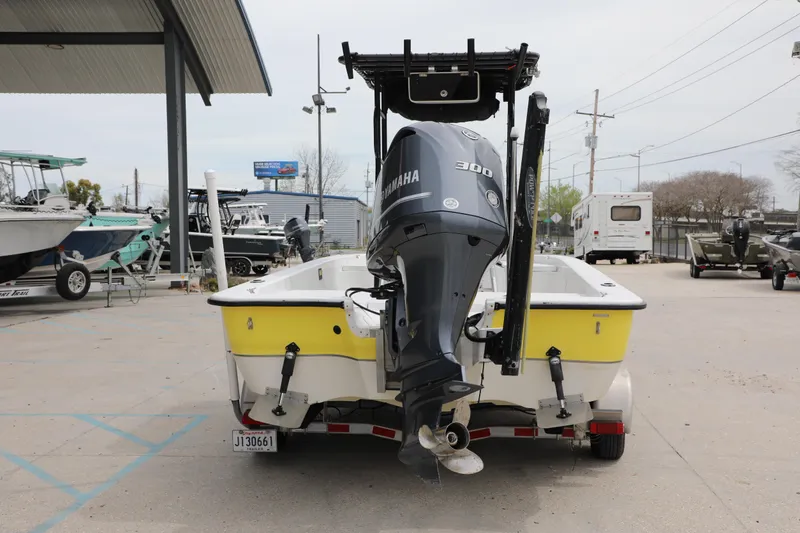 Slide: The Image of 2002 Ranger 2300 Bay Ranger boat with Yamaha 300 engine in a marina setting. - 3