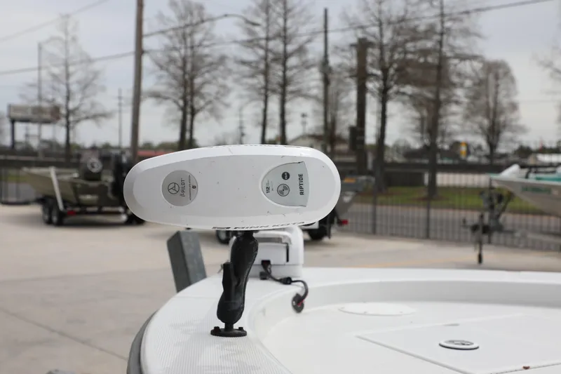 Slide: The Image of 2002 Ranger 2300 Bay Ranger boat with Minn Kota Riptide trolling motor in a marina setting. - 9