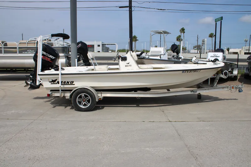 Slide: The Image of 2014 Mako 18 LTS boat on trailer, parked outdoors with Mercury engine. - 5