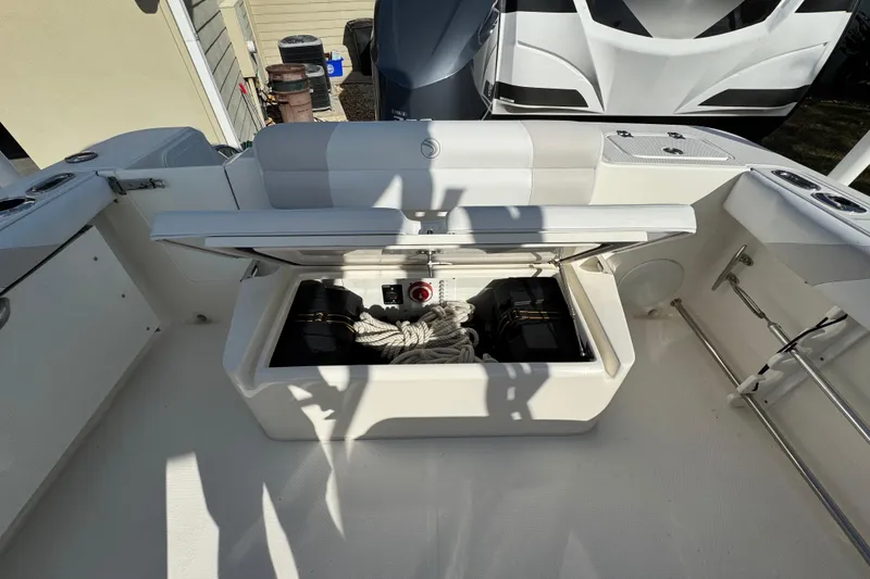 Slide: The Image of 2012 Edgewater 245CX Crossover boat storage compartment with ropes and equipment. - 10
