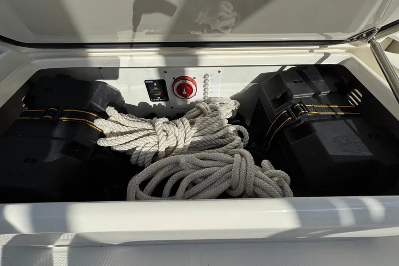 Slide: The Image of Storage compartment of 2012 Edgewater 245CX Crossover with ropes and battery boxes. - 11