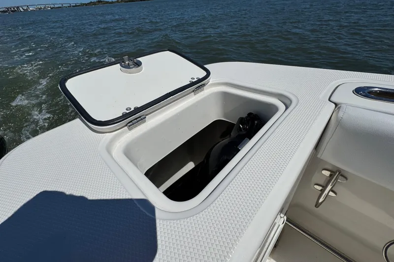 Slide: The Image of Open storage compartment on 2012 Edgewater 245CX Crossover boat, with ocean view. - 14
