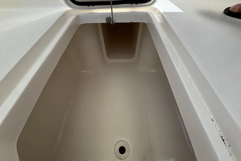 Slide: The Image of Open storage compartment on 2012 Edgewater 245CX Crossover boat. - 18