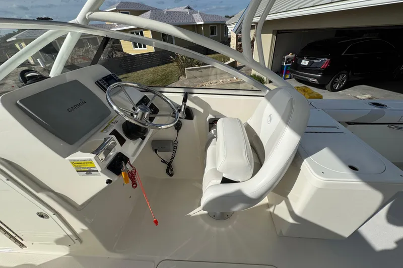 Slide: The Image of Interior of a 2012 Edgewater 245CX Crossover boat with Garmin navigation system. - 2