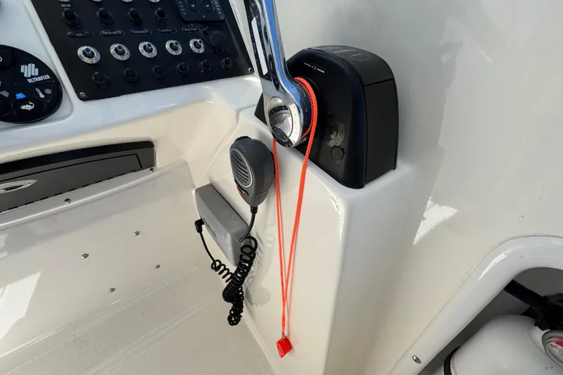 Slide: The Image of Control panel of 2012 Edgewater 245CX Crossover boat with throttle and radio. - 21