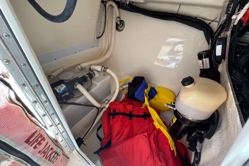 Slide: The Image of Interior of 2012 Edgewater 245CX Crossover boat with life jackets and equipment. - 23