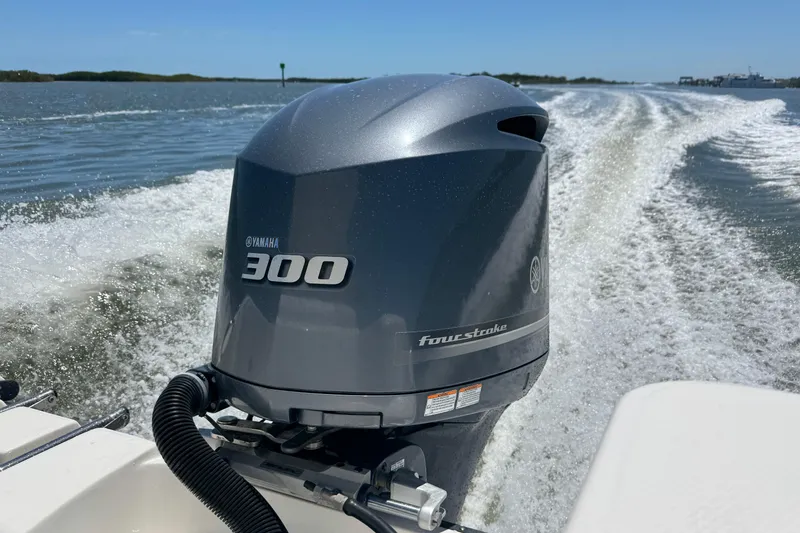 Slide: The Image of Edgewater 245CX Crossover 2012 with Yamaha 300 outboard motor on water. - 26