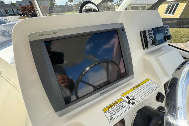 Slide: The Image of Edgewater 245CX Crossover 2012 boat dashboard with Garmin GPSmap 5212 display. - 3