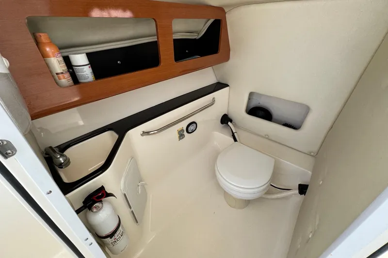 Slide: The Image of Interior of 2012 Edgewater 245CX Crossover boat bathroom with sink and toilet. - 6