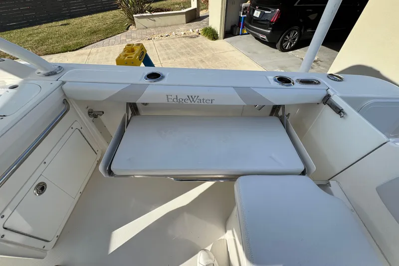 Slide: The Image of 2012 Edgewater 245CX Crossover boat interior with seating and storage compartments. - 8