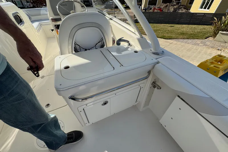 Slide: The Image of 2012 Edgewater 245CX Crossover boat interior with seating and storage compartments. - 9