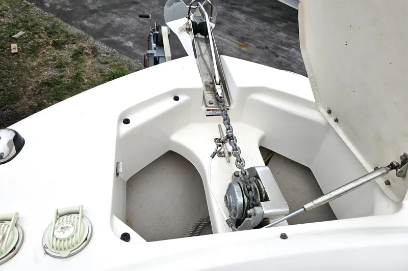 Slide: The Image of 2013 Robalo R247 Dual Console anchor compartment with chain and winch system. - 14