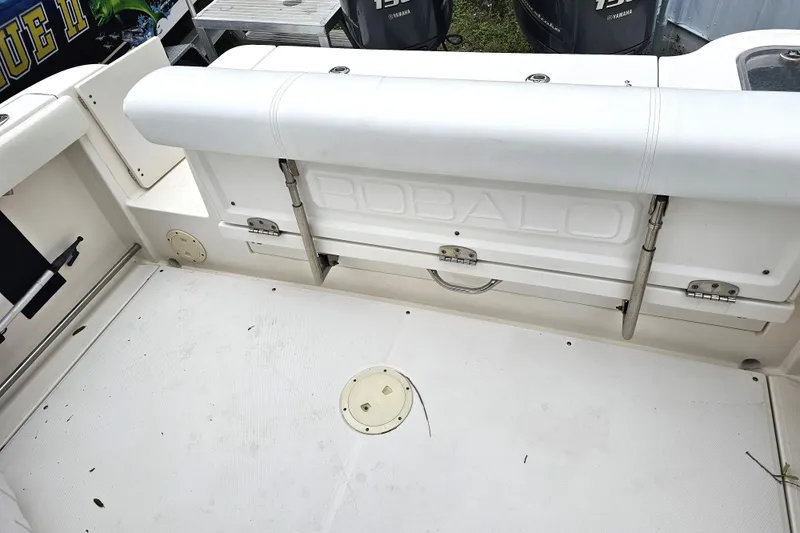Slide: The Image of 2013 Robalo R247 Dual Console boat interior with seating and storage compartments. - 24
