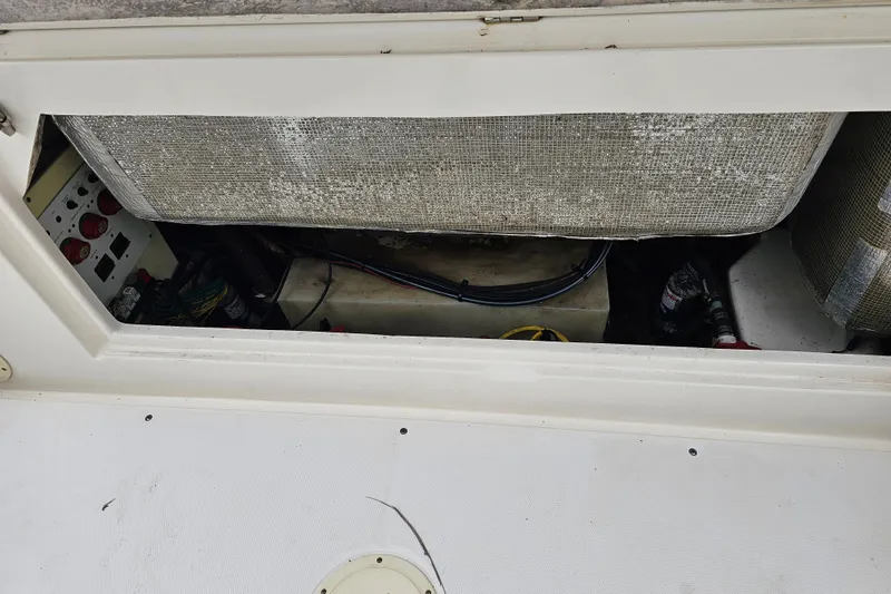 Slide: The Image of 2013 Robalo R247 Dual Console boat interior compartment with wiring and equipment. - 25