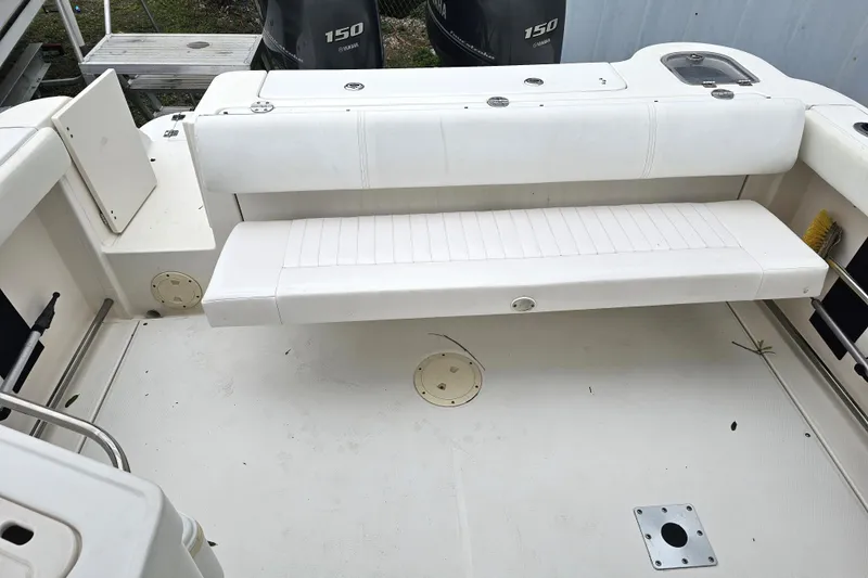 Slide: The Image of 2013 Robalo R247 Dual Console boat interior with white seating and Yamaha engines. - 26