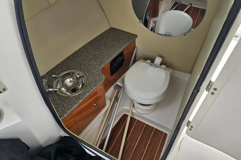 Slide: The Image of 2013 Robalo R247 Dual Console boat bathroom with sink and toilet. - 30