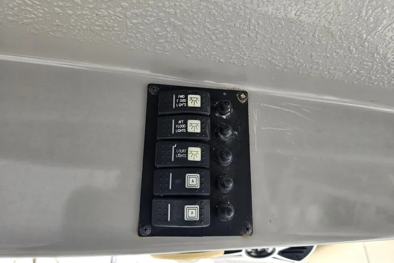 Slide: The Image of Control panel with switches for lights on a 2013 Robalo R247 Dual Console boat. - 34
