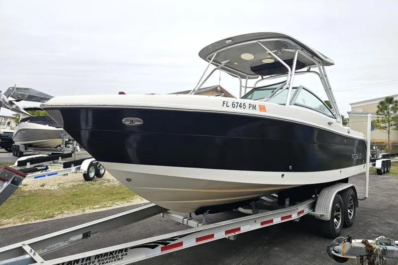 Slide: The Image of 2013 Robalo R247 Dual Console boat on trailer, parked outdoors. - 4