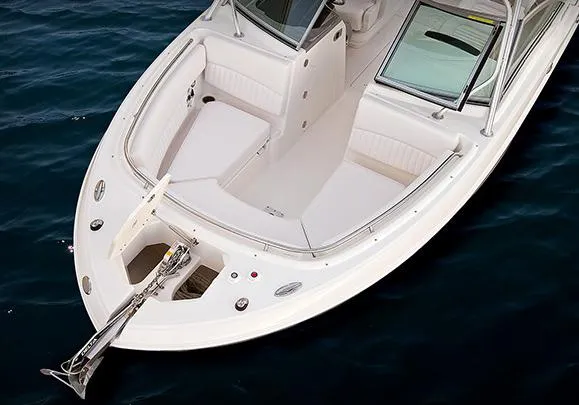 Slide: The Image of Manufacturer Provided Image: 2013 Robalo R247 Dual Console boat with spacious seating and anchor, on water. - 6