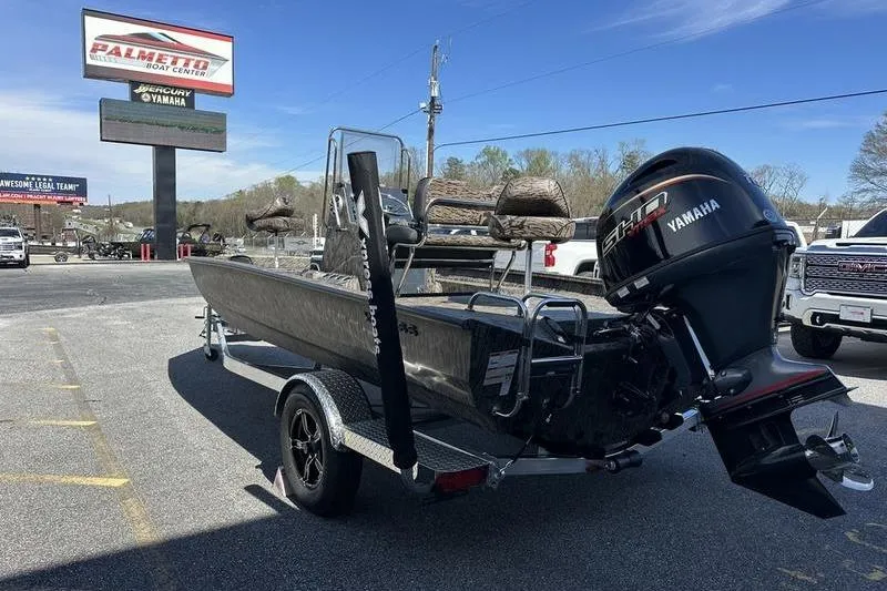 Slide: The Image of 2026 Xpress H20B Bay boat with Yamaha engine on trailer at dealership. - 5