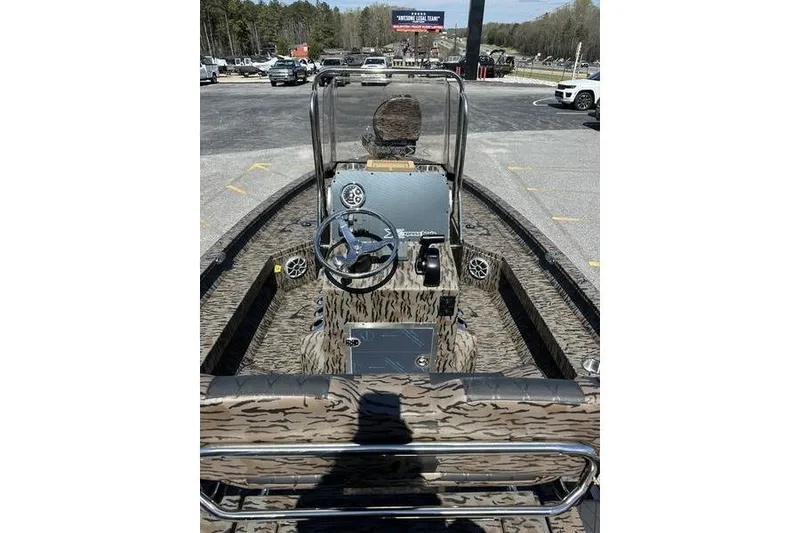 Slide: The Image of 2026 Xpress H20B Bay boat interior with camouflage design and steering console. - 7