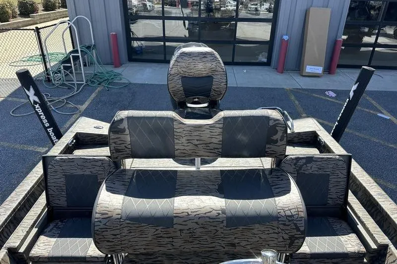 Slide: The Image of 2026 Xpress H20B Bay boat interior with camo seating and modern design. - 9