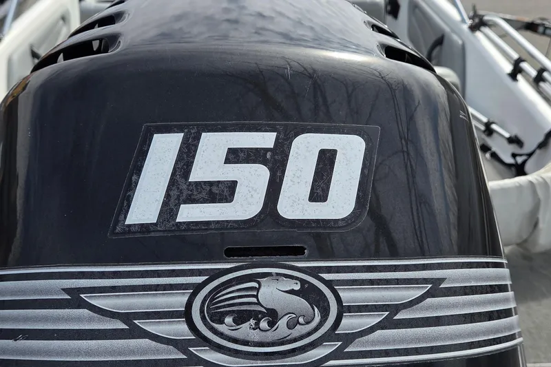 Slide: The Image of Triton SF-18 2004 outboard motor with "150" label, close-up view. - 3