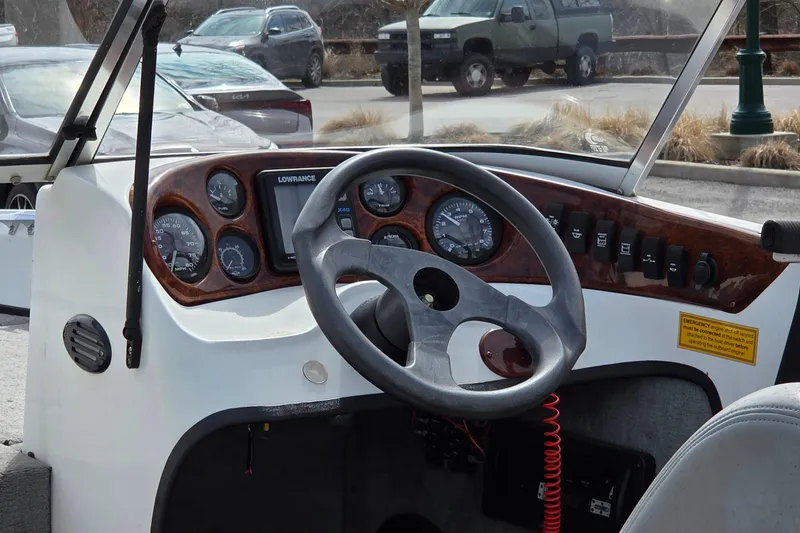 Slide: The Image of Steering console of a 2004 Triton SF-18 boat with gauges and controls. - 4