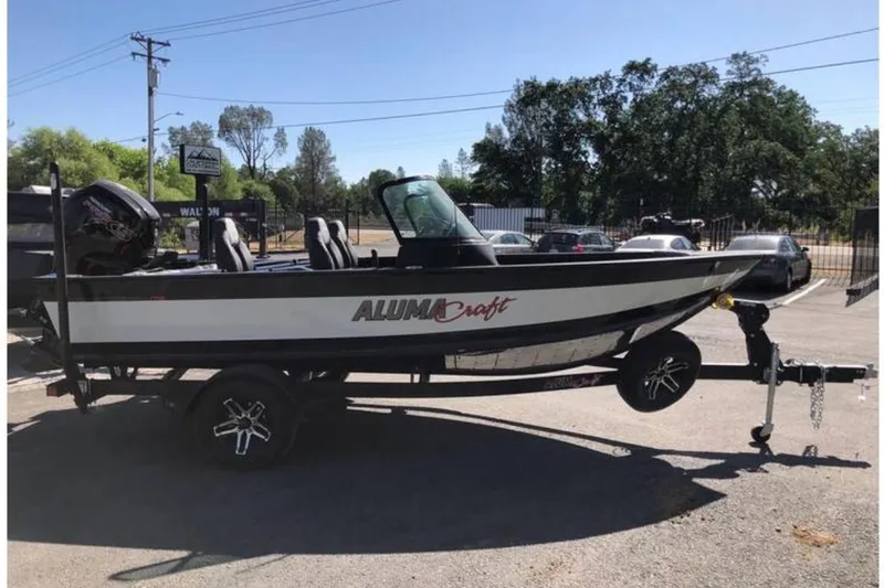 The Image of 2024 Alumacraft Competitor 175 Sport boat on trailer in parking lot. - 0