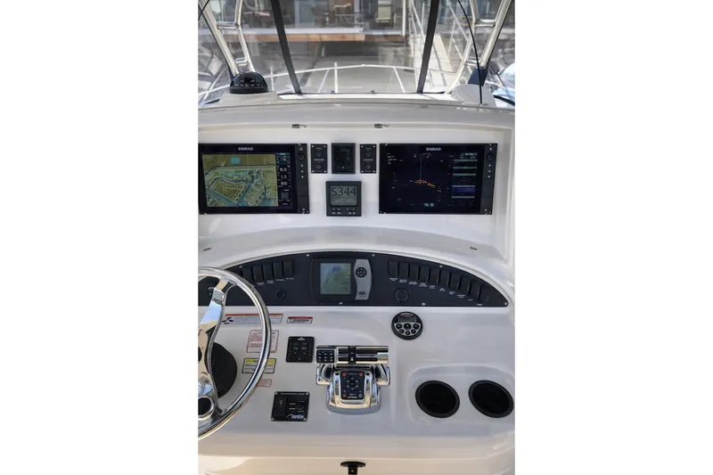 Slide: The Image of 2007 Boston Whaler 320 Outrage Cuddy Cabin helm with navigation displays and controls. - 2