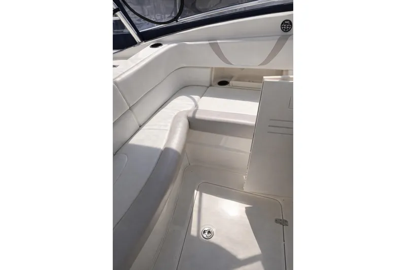 Slide: The Image of 2007 Boston Whaler 320 Outrage Cuddy Cabin interior with white seating and storage. - 5