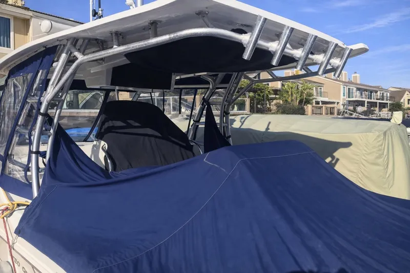 Slide: The Image of 2007 Boston Whaler 320 Outrage Cuddy Cabin with blue cover docked at marina. - 6
