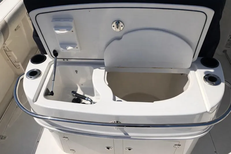Slide: The Image of 2007 Boston Whaler 320 Outrage Cuddy Cabin sink and storage area on deck. - 7