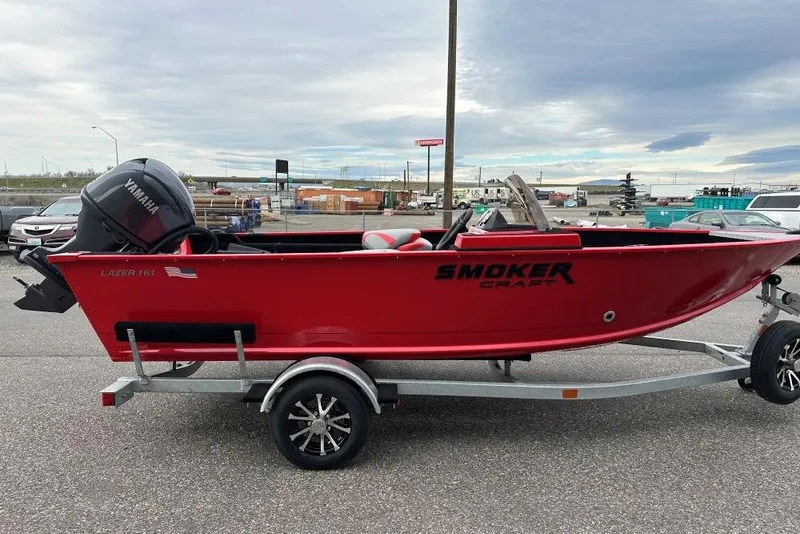 Slide: The Image of Red 2026 Smoker Craft Lazer 161 boat on trailer, equipped with Yamaha outboard motor. - 3